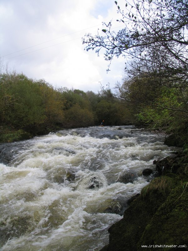  Nire River - The big rapid on the river running into a small gorge section a house is perched high on the left bank at the bottom of the rapid before the bends through the little gorge