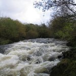  Nire River - The big rapid on the river running into a small gorge section a house is perched high on the left bank at the bottom of the rapid before the bends through the little gorge