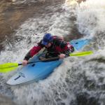 Photo of the Lower Corrib river in County Galway Ireland. Pictures of Irish whitewater kayaking and canoeing. Steve Hynes on O'Brien's Wave on 16 gates. Photo by Sorcha Schnittger