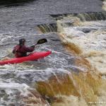 Photo of the Ennistymon Falls in County Clare Ireland. Pictures of Irish whitewater kayaking and canoeing. Dave Clarke lining a drop. Photo by Tiernan