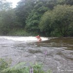 Photo of the Erriff river in County Mayo Ireland. Pictures of Irish whitewater kayaking and canoeing. me havin a play on the upper wave. Photo by tom ob