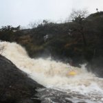 Photo of the Owenaher river in County Sligo Ireland. Pictures of Irish whitewater kayaking and canoeing. Andrew Regan, taking a stroke going through the stopper. Photo by Andrew Regan