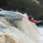 Photo of the Ennistymon Falls in County Clare Ireland. Pictures of Irish whitewater kayaking and canoeing. Dave Clarke boofing main drop. Photo by Tiernan