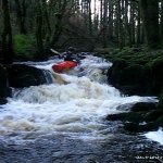 Photo of the Glensheelan river in County Waterford Ireland. Pictures of Irish whitewater kayaking and canoeing. kevin on the first small drop after the broken foot bridge. Photo by Michael Flynn